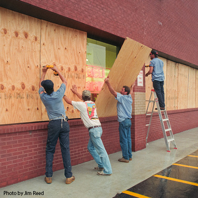 Windows are boarded up before a hurricane.